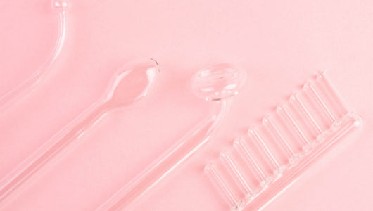 High frequency facial tools on pink background in red light therapy vs high frequency skincare comparison