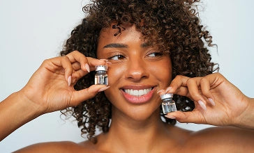 Woman holding skincare product vials