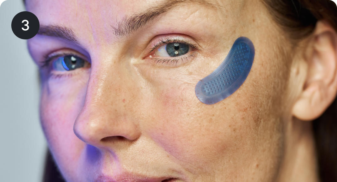 Woman with blue eye patch on face.