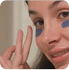 woman with eye patches giving the okay sign