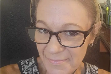 Lena wearing glasses smiling