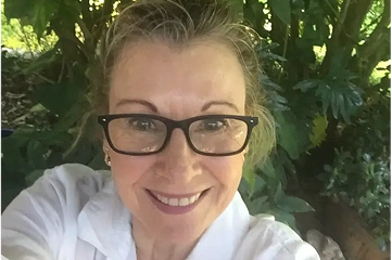 Tina smiling wearing glasses